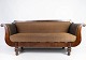 Antique sofa upholstered with brown fabric and frame of dark wood from 1860.
5000m2 showroom.
